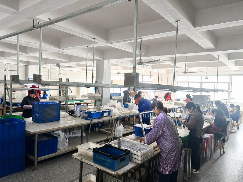 Fishing lure component installation and final assembly line Fishing lure component installation and final assembly line
